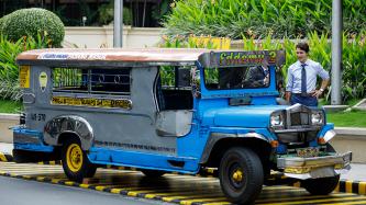 Prime Minister Justin Trudeau is shown an old and worn down Jeepney public transit vehicle