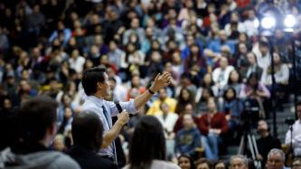 Prime Minister Justin Trudeau addresses the crowd during a town hall discussion in a gymnasium.