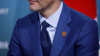 Prime Minister Trudeau wears a pin of the Charlevoix G7 Summit.
