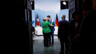 Prime Minister Trudeau gives a hug to Chancellor Angela Merkel.