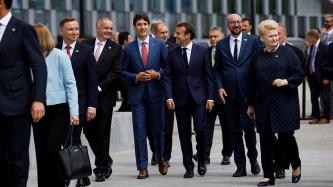 Prime Minister Trudeau walks outside with other NATO leaders.