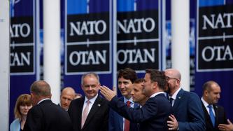 Prime Minister Trudeau talks outside with other NATO leaders.