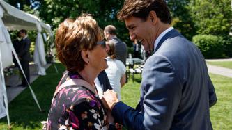 PM Trudeau shakes hands with a woman