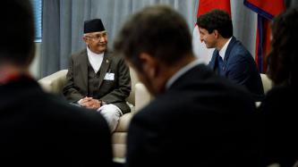 PM Trudeau listens to PM Oli