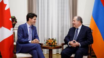PM Trudeau sits and listens to President Sarkissian