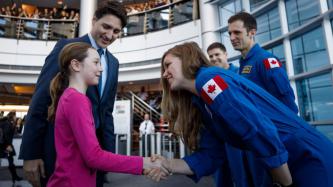 Ella-Grace shakes hands with astronaut Jenni Sidey