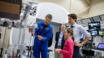 Ella-Grace and PM Trudeau watch a demonstration