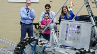 Ella-Grace et le PM Trudeau manient un véhicule robotisé