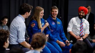 Astronaut Jenni Sidey speaks to the crowd during a panel