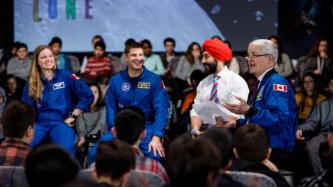 Minister Garneau speaks while the panelists look on