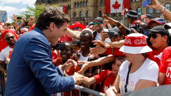 PM Trudeau greets a young girl in a crowd