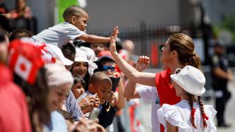 Sophie Grégoire Trudeau high fives a boy