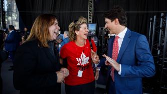 PM Trudeau speaks with Alan Doyle and a woman