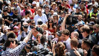 PM Trudeau stands in a crowd