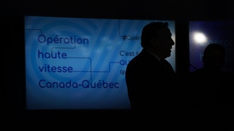 Premier Legault’s silhouette as he stands in front of a screen