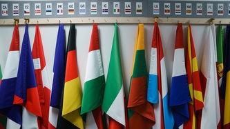 Flags of countries are hung on a wall