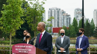 Minister Hussen speaks at the podium