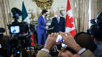 Mexico's President Obrador and Prime Minister Trudeau shake hands in front of media