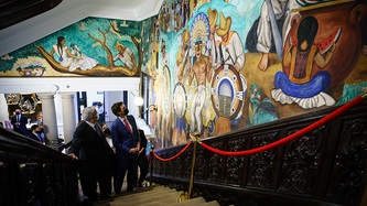 Mexico's President Obrador and Prime Minister Trudeau in a stairwell look at art on the wall